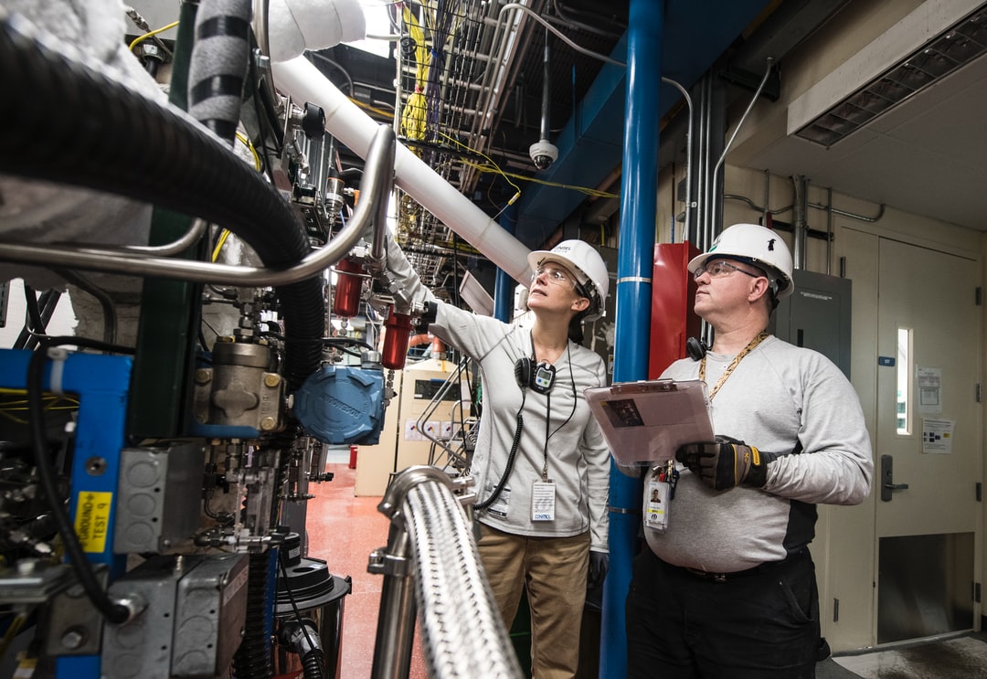 NREL Thermochemical Process/ Control Engineer and Research Technician work during a 48 hour Hot Test in Thermochemical User Facility Pilot Plant in the Field Test Laboratory Building (FTLB).